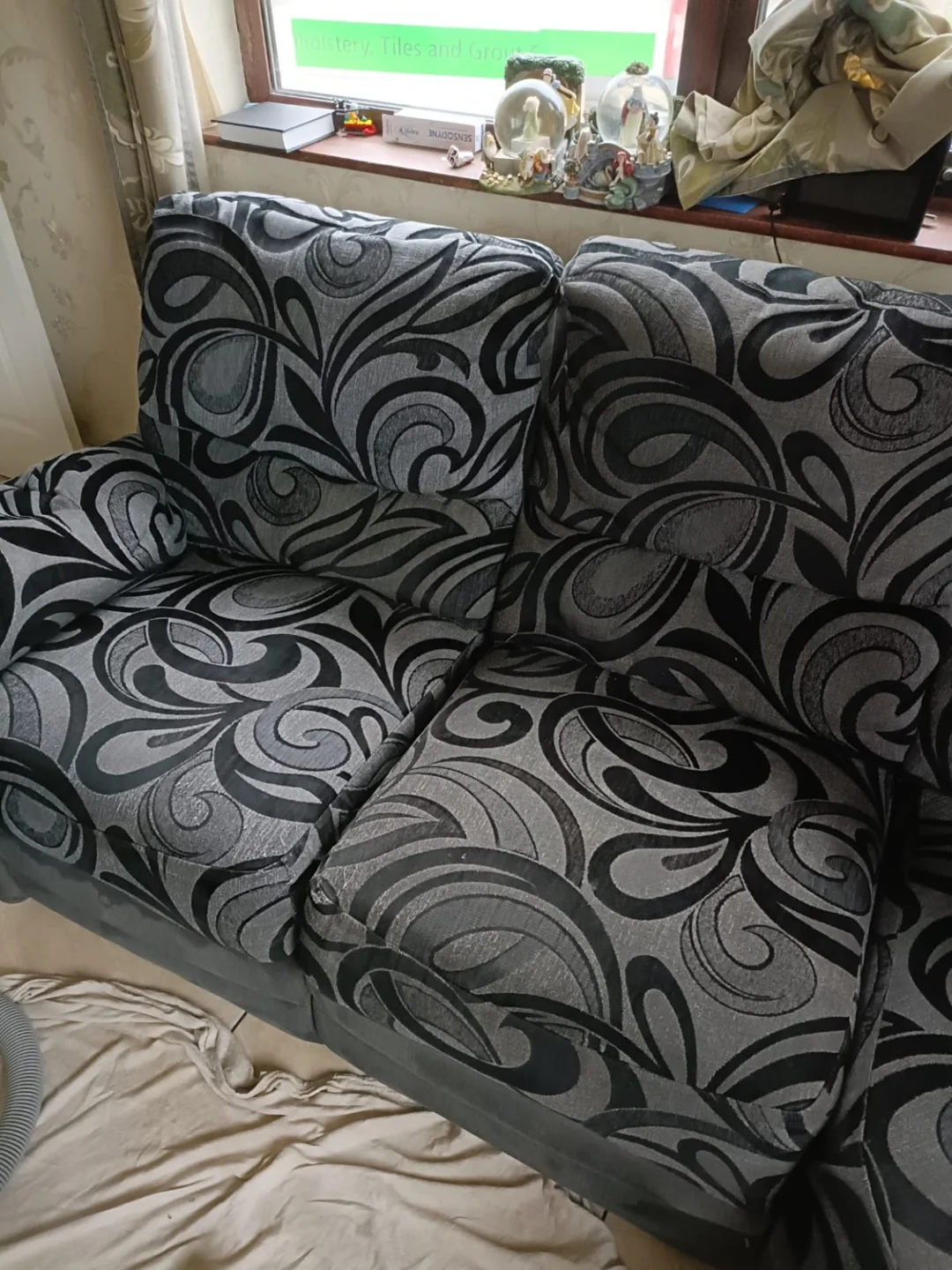 Grey and black patterned fabric sofa with two seat cushions
